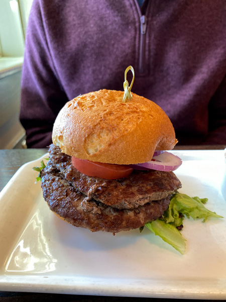 Cedrics Tavern Gluten Free Burger Asheville with two beef patties on gluten free bun with lettuce, onion, and tomato