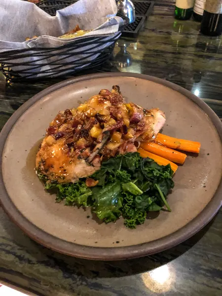 Entree Chestnut Restaurant Asheville NC with roasted chicken, carrots, and green
