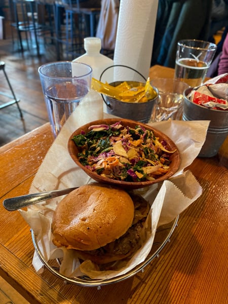 Gluten free Farm Burger Downtown Asheville NC with burger in basket with slaw and glass of water