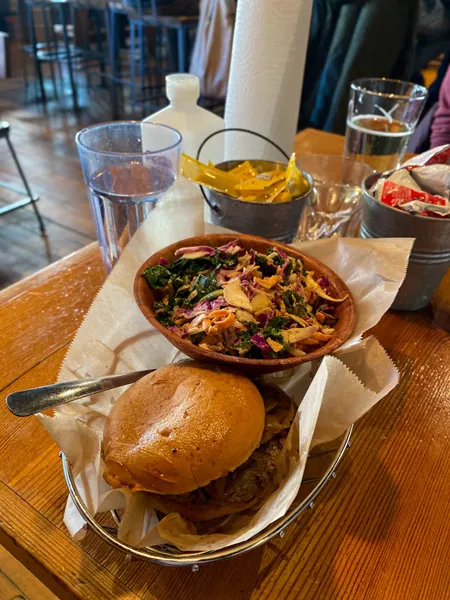 Gluten free Farm Burger Downtown Asheville NC with burger in basket with slaw and glass of water