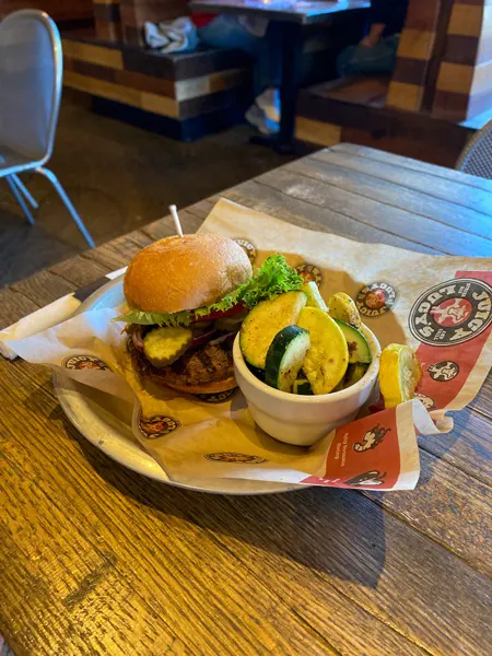 Juicy Lucy's Asheville NC Gluten free burger with roasted veggie side on a plate