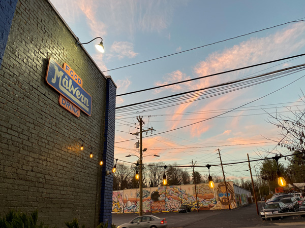 The Malvern West Asheville NC with outside of building and The Dude Abides Gus Mural on Sky Lanes Bowling