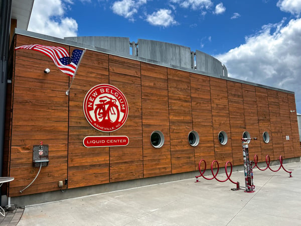 New Belgium Brewing Company in Asheville North Carolina liquid facility with signs and brown enclosure around steel fermentation tanks