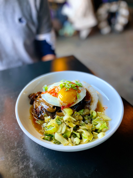 RosaBees Restaurant Asheville NC with egg and veggies over rice in white bowl on table