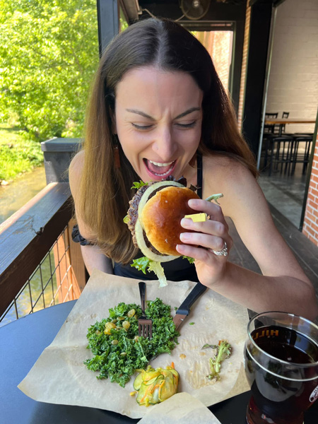 Christine eating Hillman Beer burger