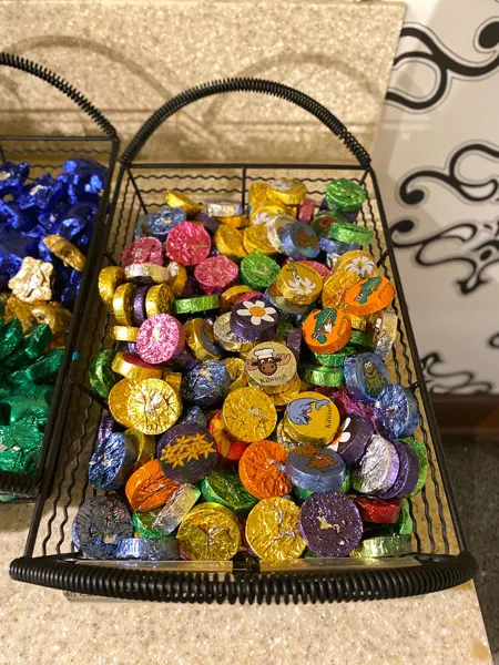 Kilwins Asheville Chocolate Shop with brightly foiled colored chocolates in a basket