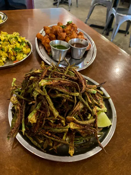 Okra fries from Chai Pani Indian restaurant Asheville NC with green okra cut in thin shaped fries and garnished with lime