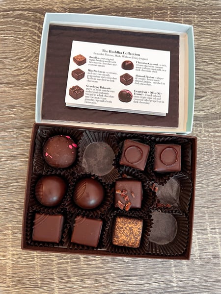 Vegan Truffles French Broad Chocolate Asheville NC with open box of 12 varying flavor truffles from their Buddha Collection