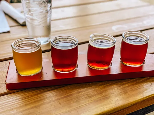 Rye Knot Restaurant Distillery Brewery Asheville NC with flight of 4 beer glasses mostly amber in color with one yellow beer