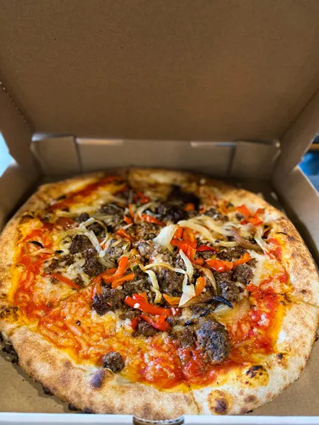White Labs Brewing Kitchen And Tap Asheville pizza with regular crust, peppers, meats, and red tomato sauce