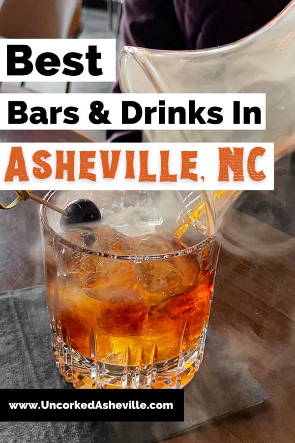 Best Asheville Bars with low ball brown cocktail with black cherry garnish and smoke