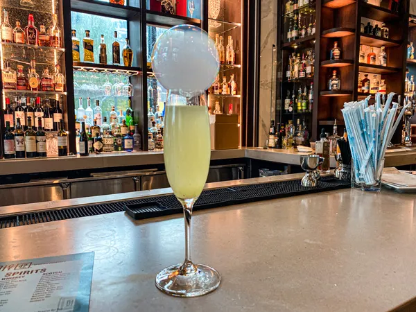 District 42 Bar Downtown Asheville with champagne cocktail with bubble on bar