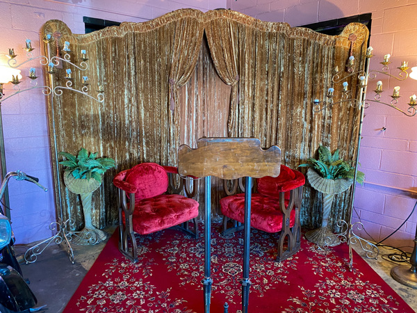 Fleetwoods Chapel Rock and Roll bar Asheville with two velvet red chairs and brown podium with brown curtains