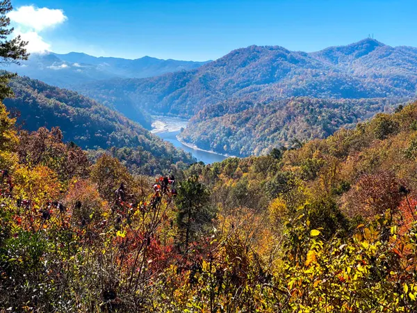 Fontana Lake Near Asheville NC with blue water from above with fall foliages and mountains surrounding it