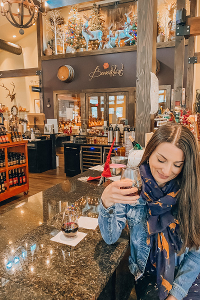 Burntshirt Vineyards Tasting Room Chimney Rock NC with white brunette woman holding red glass on wine at bar