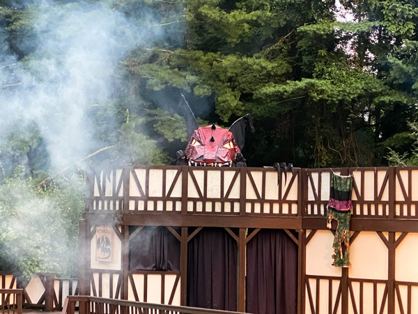 Theater in the Park Asheville NC with red and black dragon with smoke coming over stage