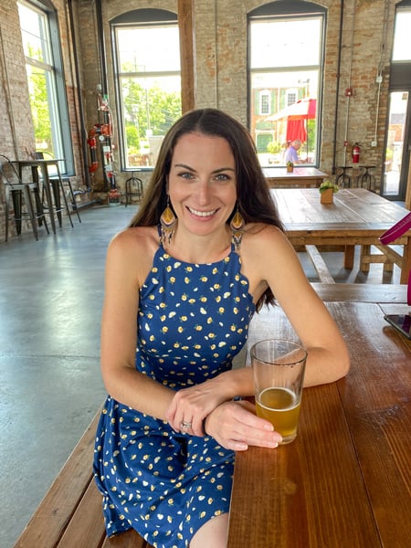 BrickTree Brewing Co Lincolnton NC with white brunette female in blue dress drinking a light beer at a table in a taproom