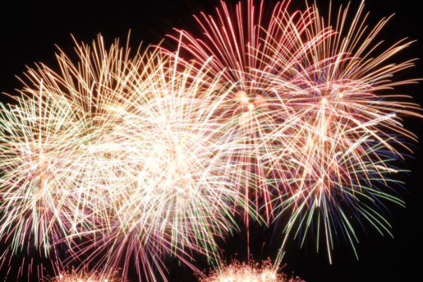 Red and gold series of fireworks in black sky