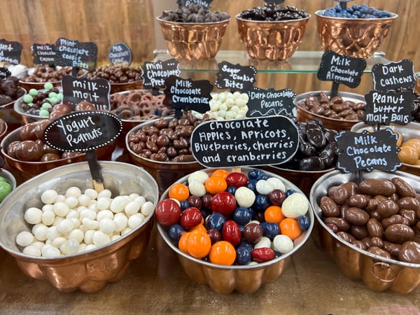 Jelly Bellies Mountain Market Maggie Valley North Carolina with tin bowls filled with specialty chocolates with chalk on blackboard like labels