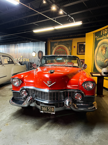 Wheels Through Time Motorcycle Museum Maggie Valley NC with front of antique red Cadillac 