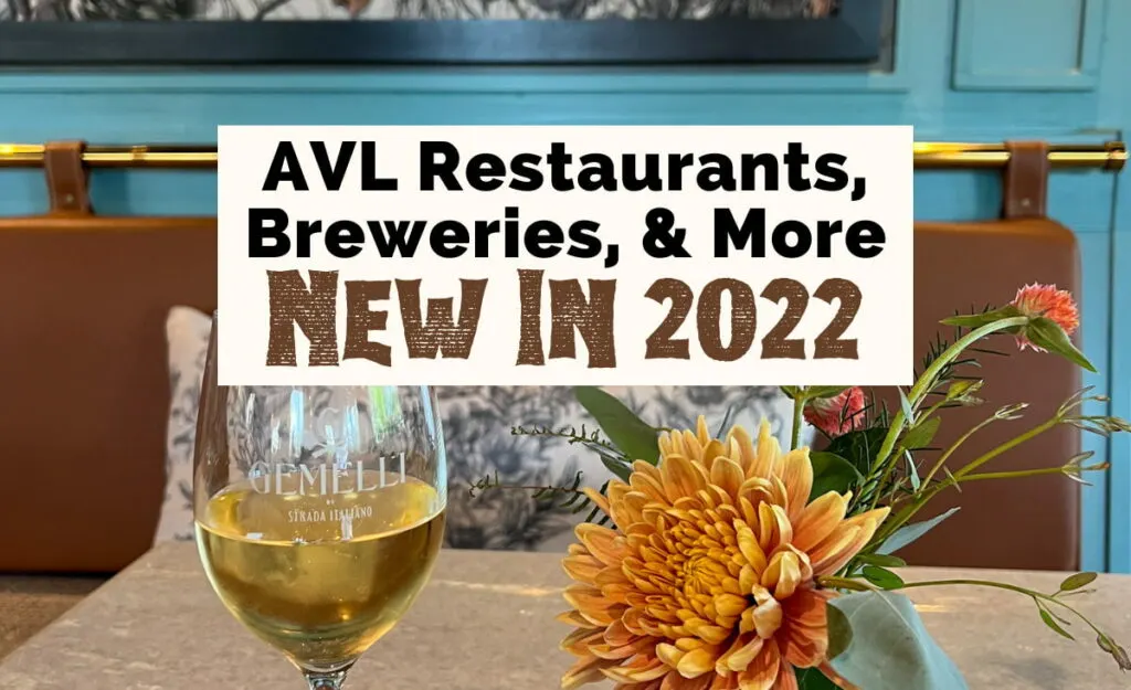 New In Asheville 2022 including Restaurants, Breweries, and Hotels with image of new restaurant Gemelli with white glass of wine and orange flowers in vase on table with turquoise wall