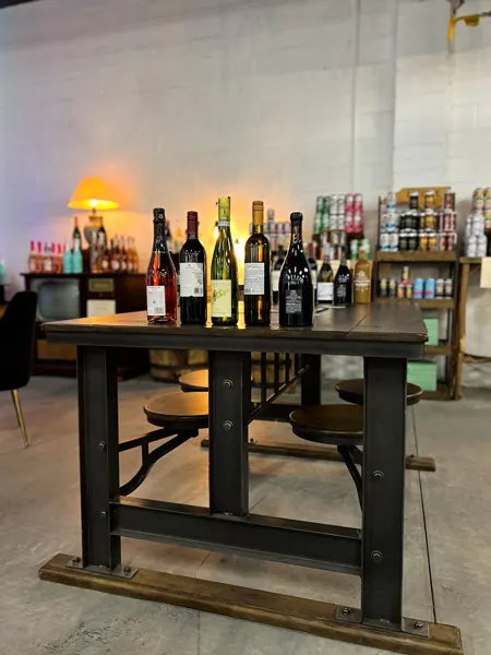 Saint Brighids Bar Marquee Asheville North Carolina with white bottles lined up on brown table in bar seating area