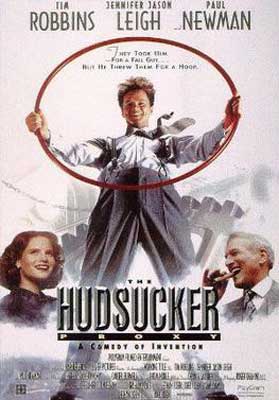 The Hudsucker Proxy Movie Poster with man holding red ring and two people standing along side him
