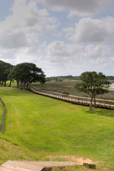 Fort Fisher in North Carolina with green grass surrounded by wood fence on each side