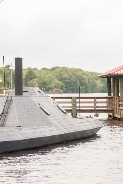 Replica of the CSS Albemarle in North Carolina with image of small gray like submarine/ship at wooden dock