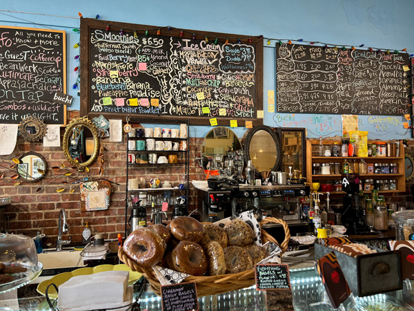 Artisun Gallery and Cafe in Hot Springs NC with smoothie and coffee menu boards on wall and baked goods on counter