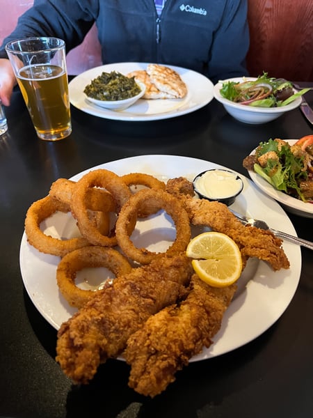 Iron Horse Station Restaurant and Tavern in Hot Springs, NC with photo of fried catfish on white plate with mayo, fried onion rings, and plate of grilled chicken and collard greens in background