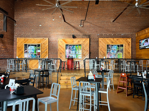 Village Pub in Biltmore Village in Asheville NC with faux windows on wall with large restaurant with tables and chairs