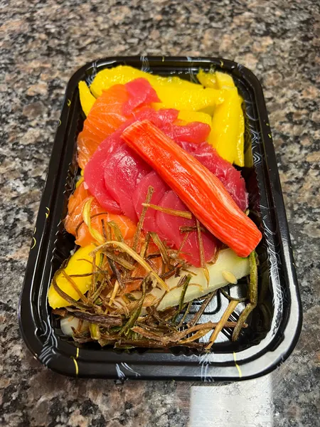 Red Ginger dimsum and tapas Asheville sushi takeout with crab sticks, tuna, and mango in black takeaway container