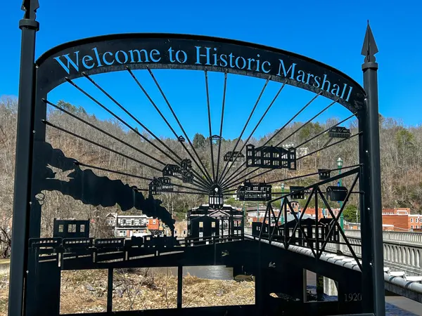 Blannahassett Island in Historic Marshall NC welcome sign with images of landmarks and houses that line up with the part see-through sign