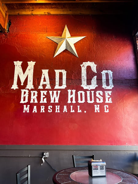Mad Co Brew House Marshall NC white lettering on bright red wall with star above