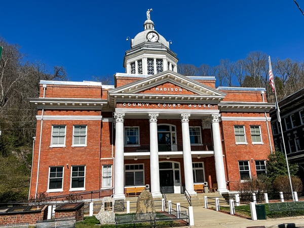 Madison County Courthouse in Marshall NC with two story historic brick building with clock on top