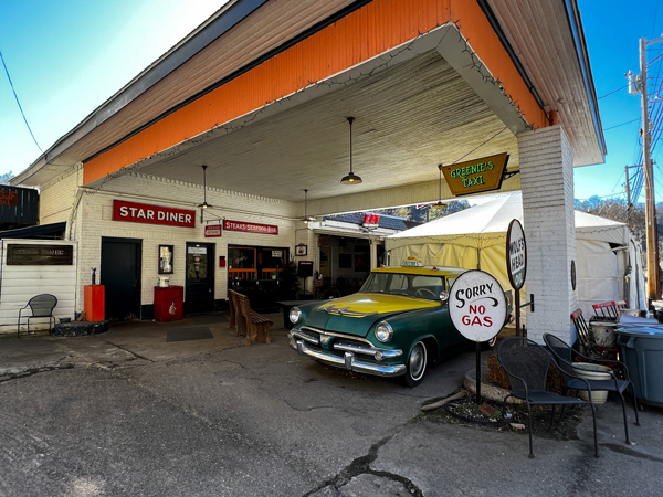 Star Diner in Downtown Marshall North Carolina with image of gas station facade for restaurant with old green and yellow car and sign that says sorry no gas