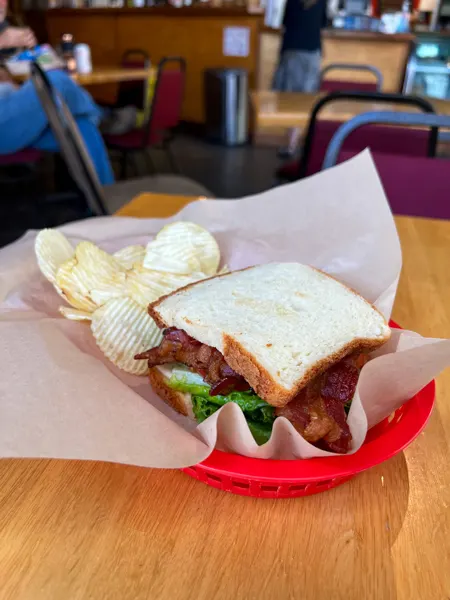 Zuma Coffee in Marshall NC Gluten Free BLT with lettuce, bacon and tomato on gf white bread with chips in red basket with paper