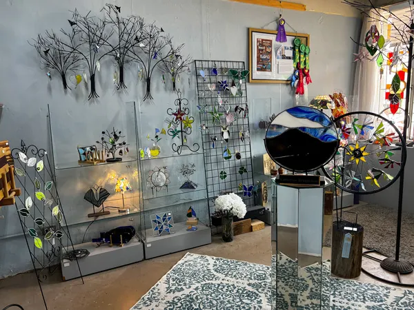 Arrowhead Gallery & Studios in Old Fort North Carolina with gray walls cover in handcrafted wire art in the shape of trees and nature-themed sculptures