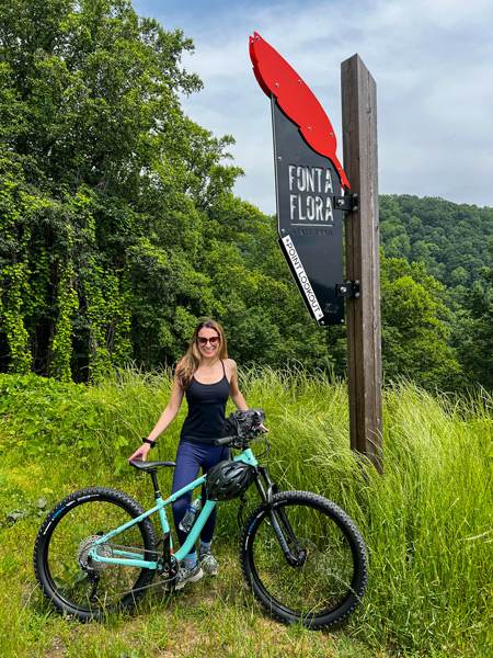 Christine with mountain bike and Fonta Flora sign