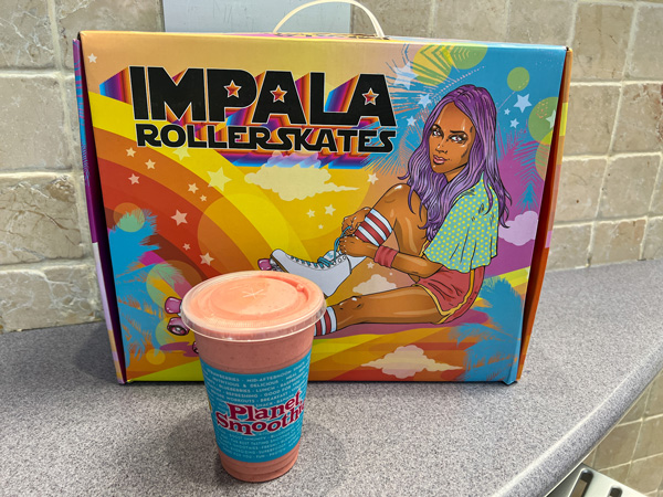 Asheville Mall in Asheville NC with Impala roller skate box and Planet Smoothie pink beverage