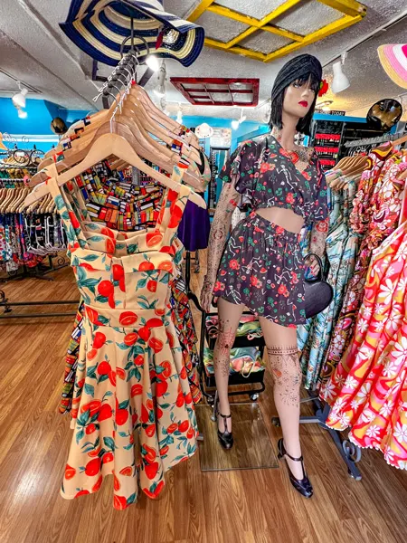 Lost and Found Shop Downtown Asheville NC with dress with orange print and mannequin wearing printed outfit