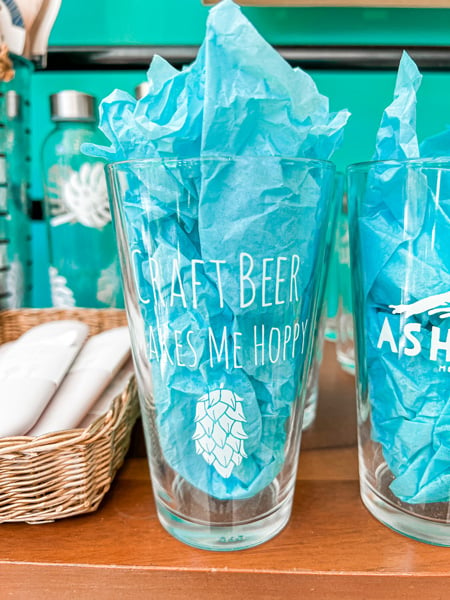 Moonlight Makers Shop in Asheville NC with beer glasses that say craft beer makes me hoppy with turquoise tissue paper in them