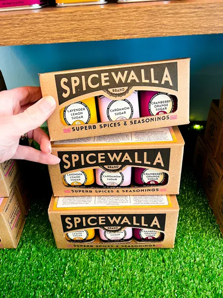 Spicewalla Asheville NC Shop with white hand holding up package of mixed sugars