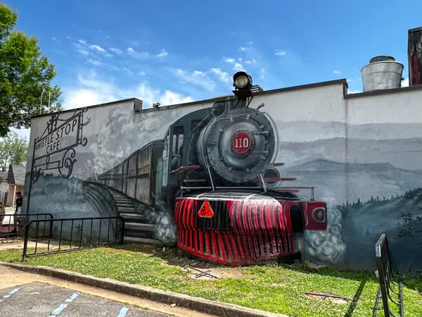 Whistle Stop at the American Cafe in Travelers Rest SC with facade of building with large train