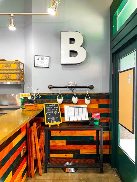 Bebettes Coffee Shop Downtown Asheville NC with shiplap like counter, the letter B for wall decor, and menus