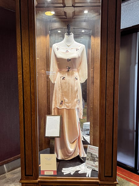 Pink Lady legend at the Omni Grove Park Inn in Asheville with old fashioned pink flower dress in display case with signage
