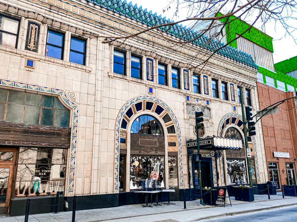 The Times Bar and Coffee Shop Downtown Asheville North Carolina facade along with S & Market building which is tan stone with arch doorway and blue windows on top