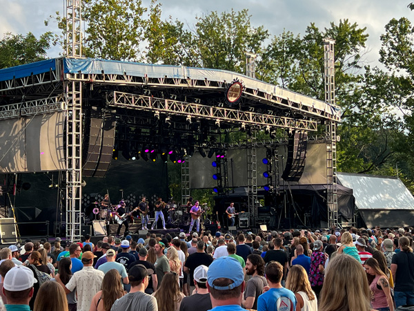 Salvage Station Music Venue in Asheville NC outdoor Concert with band on stage surrounded by people