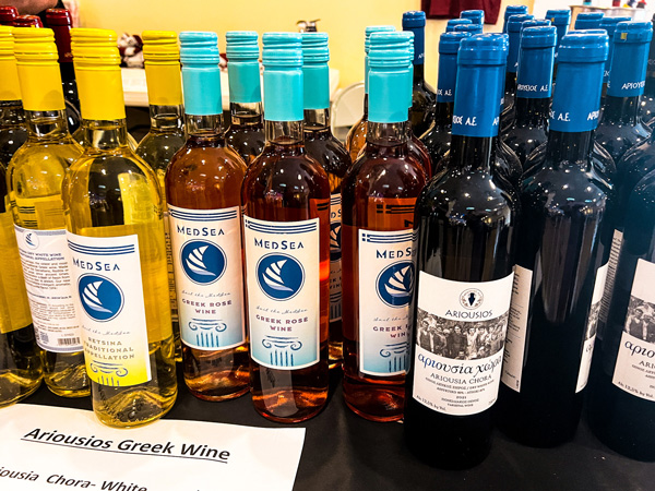 Asheville Greek Festival bottles of red, white, and rose Greek wine on table